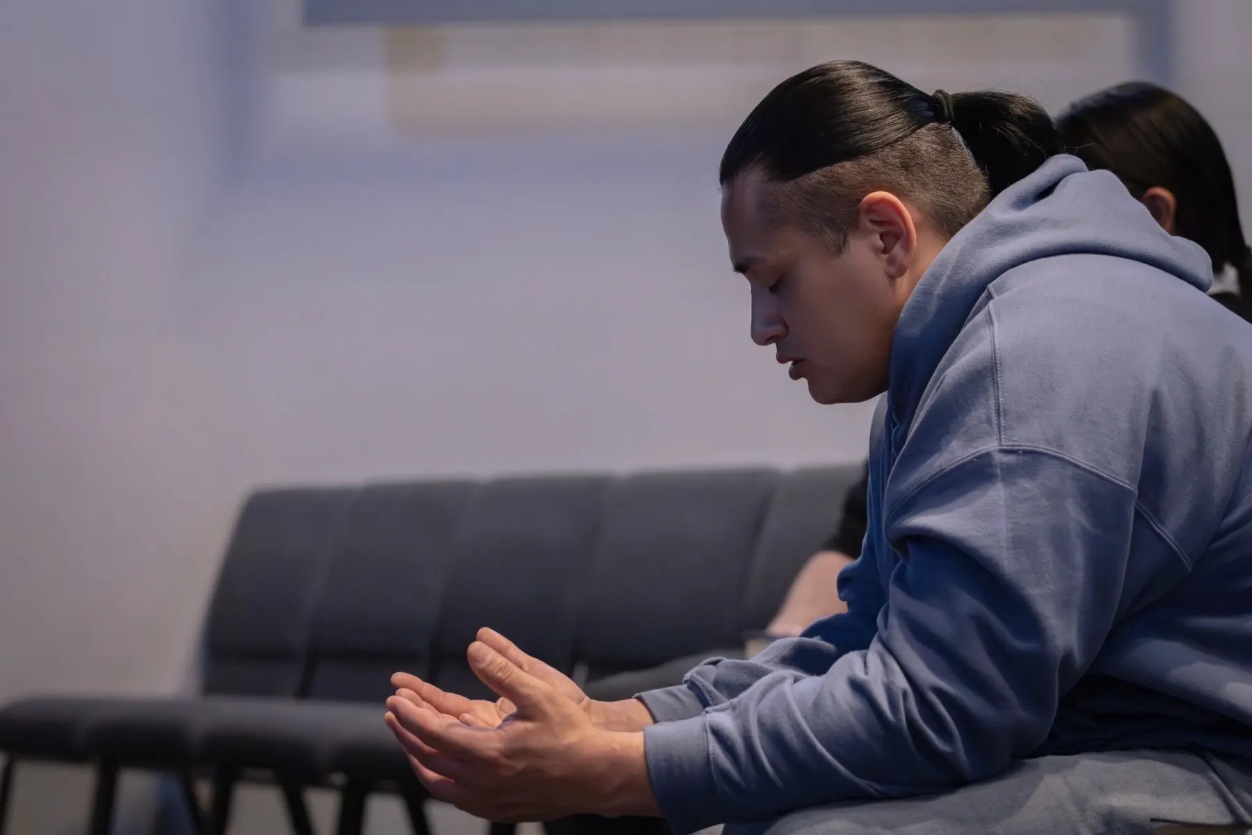 Young man praying during service
