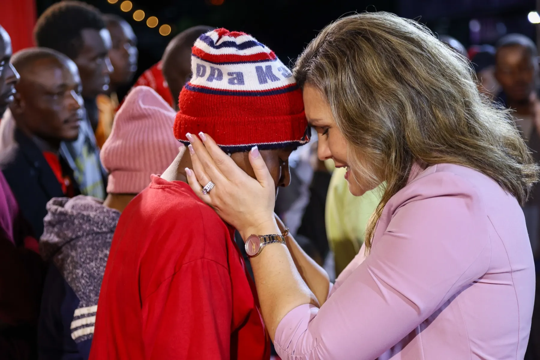 Pastor Hannah praying with someone during missions ministry
