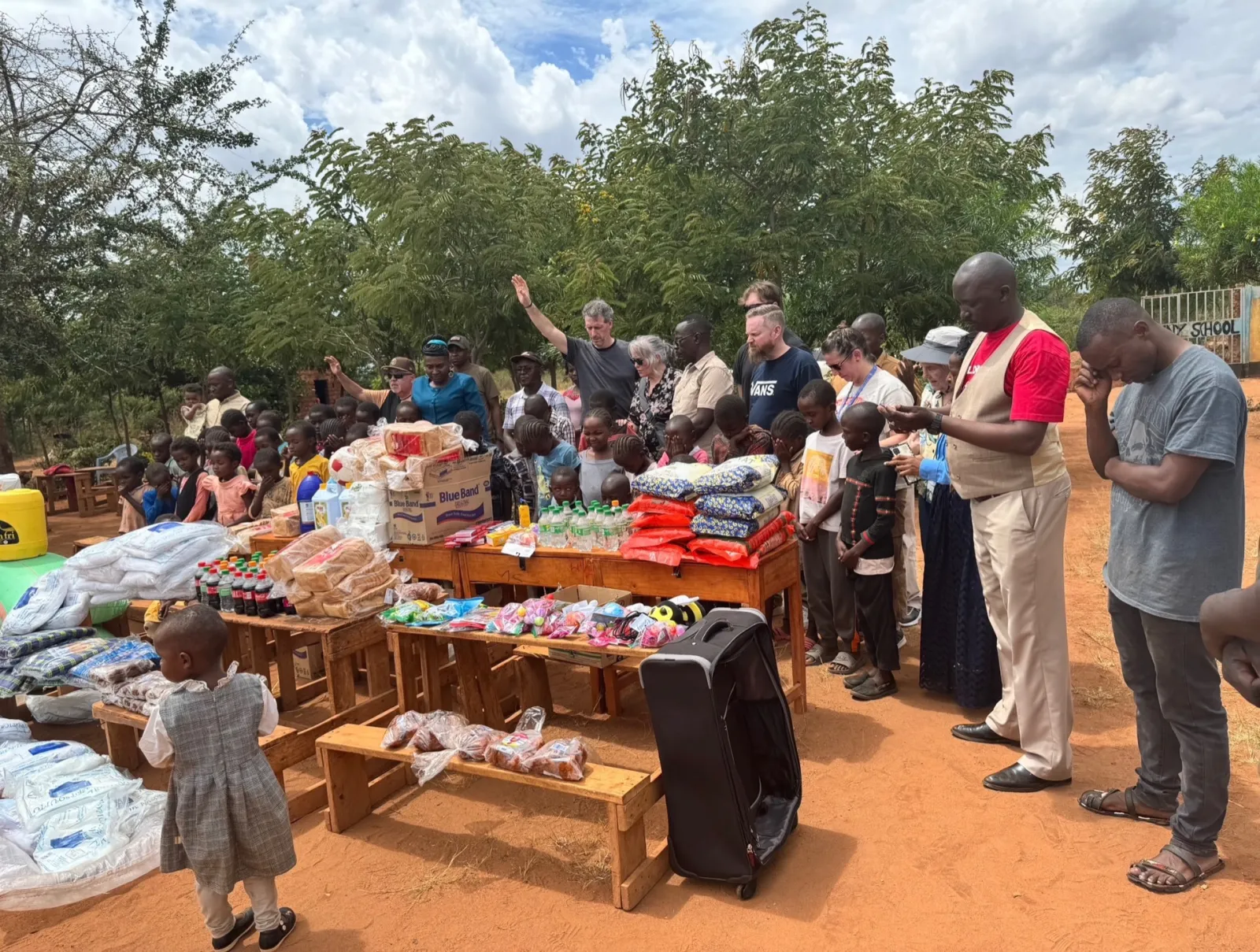Mission team praying over supplies for children