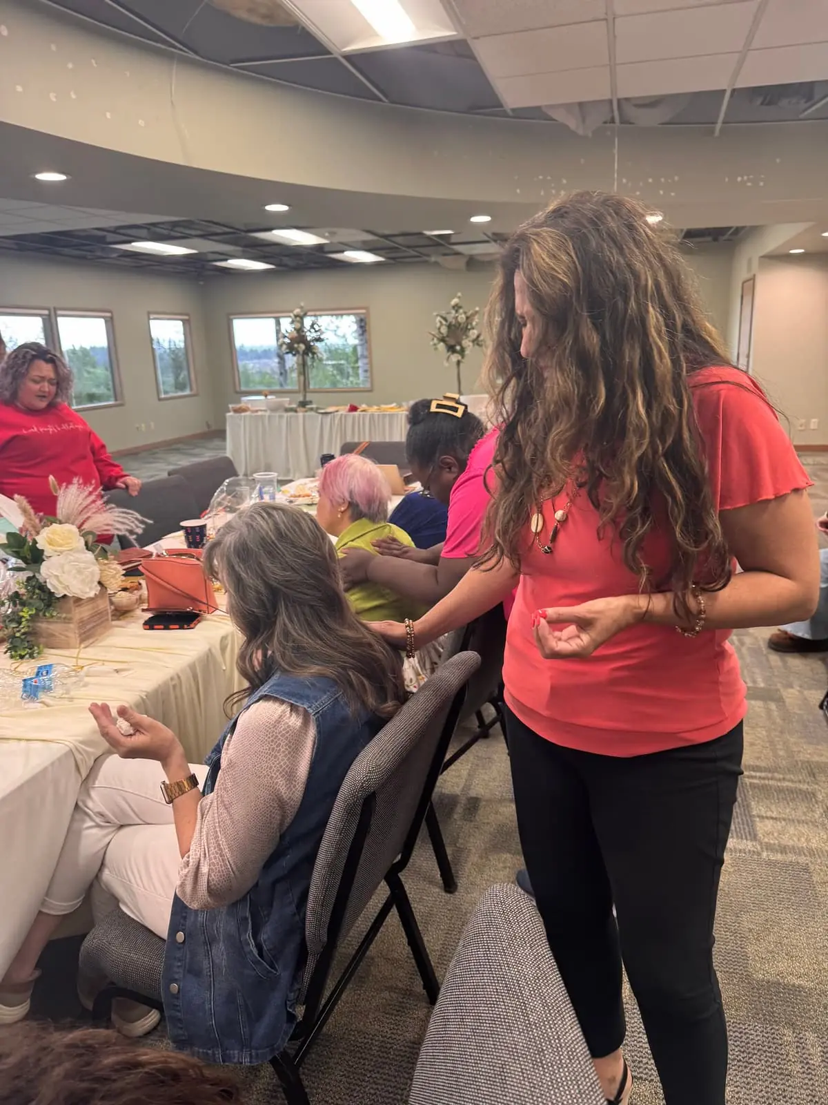 Women connecting and praying during a Women's Ministry gathering