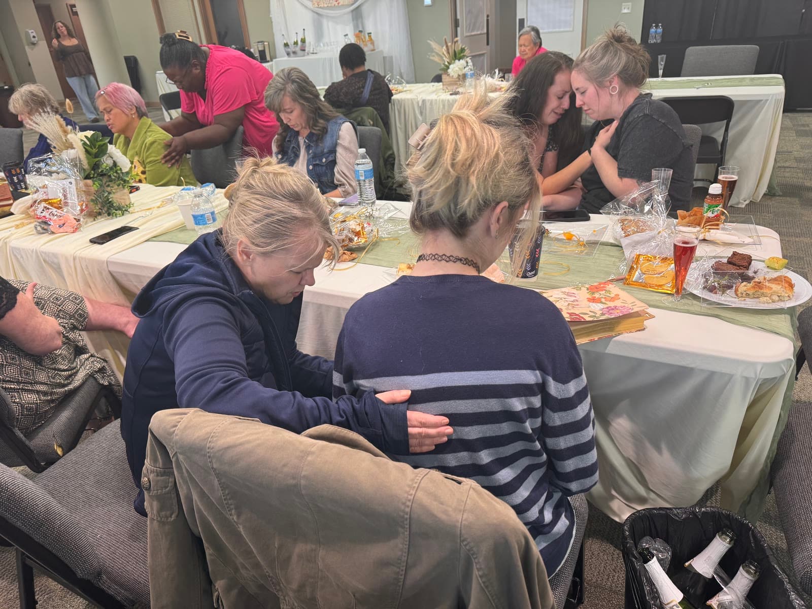 Women praying for and encouraging one another