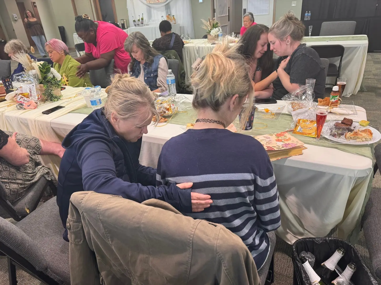 Women praying for and encouraging one another